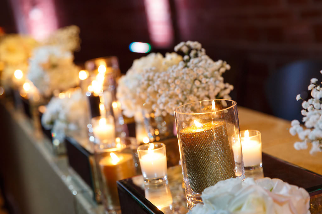Gold Glitter Candles and Votives with White Hydrangea and Babysbreath Centerpieces on Mirrored Stands | New Year's Eve Wedding Reception Decor