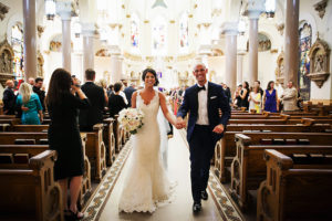 Bride and Groom Walking Down Aisle at Tampa Catholic Wedding Ceremony at Sacred Heart Church | Tampa Wedding Photographer Limelight Photography