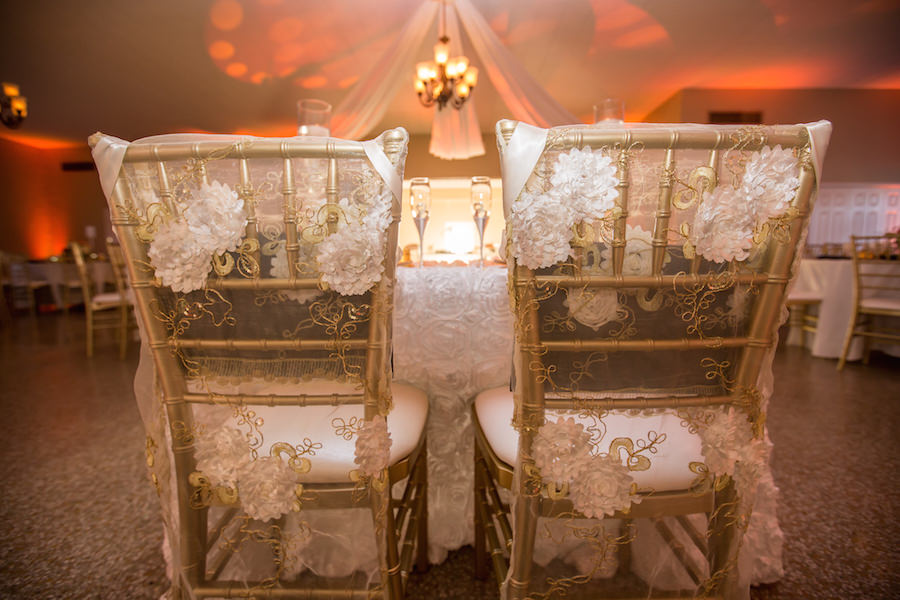 Wedding Reception Gold Chiavari Chairs with Sheer Chair Covers and White Rosette Covers