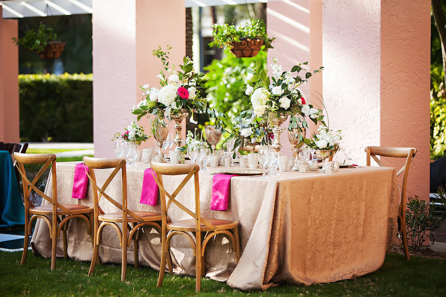 Garden Wedding Decor with Wooden Chairs, and White Centerpieces with Greenery | St. Petersburg Event Chair Rentals Signature Event Rentals and Wedding Florist Wonderland Floral Art