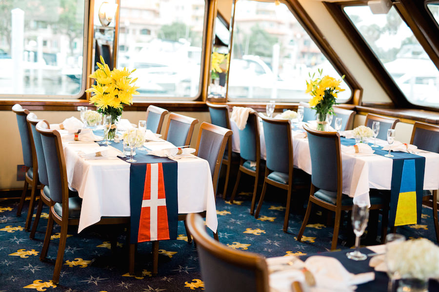 Nautical Inspired Wedding Reception Décor with Navy Table Runner and Yellow Spider Mum Centerpieces on Feasting Tables | St. Petersburg Wedding Venue Yacht Starship