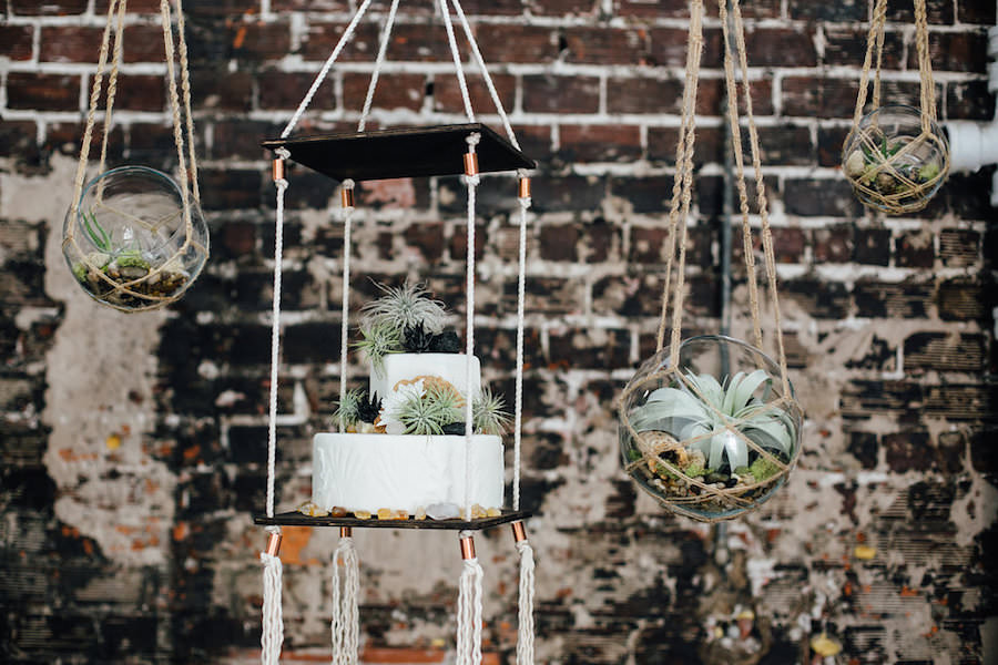 Two Tier, Round White Suspended Wedding Cake with Greenery Accents and Suspended Plant Terrariums | Tampa Wedding Florist Florist Fire