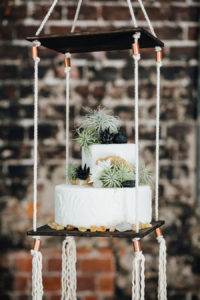 Two Tier, Round White Suspended Wedding Cake with Greenery Accents