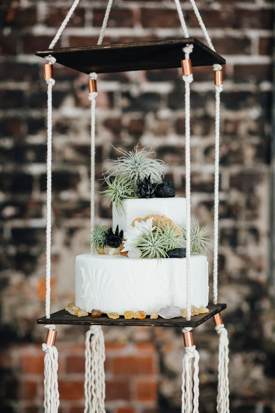 Two Tier Round White Suspended Wedding Cake With Greenery Accents