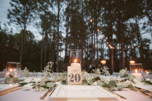 Rustic Wedding Table Dressing with Baby’s Breath, White Candles and Greenery on Light Pink Tablecloths with Gold Accent | Tampa Bay Wedding Floral Designer Northside Florist