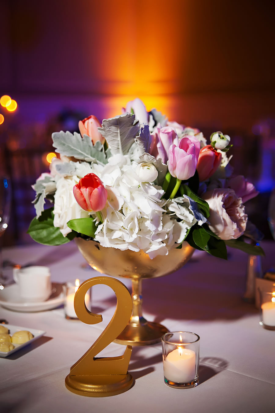 Wedding Reception Table Decor with Gold Table Numbers and Pink, Red, and White Floral Centerpieces with Succulents