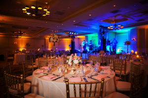 Tampa Hotel Wedding Reception Decor with Gold Chiavari Chairs, Pink, Red, and White Floral Centerpieces and Wedding Reception Decor with Projection Floor GOBO Monogram, and Blue Uplighting | Tampa Wedding Lighting Gabro Event Services