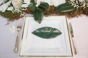 Rustic Wedding Table Setting and Name Card with Ivory Rose Petals, Baby’s Breath and Greenery | Tampa Bay Wedding Planner Glitz Events