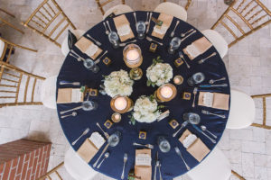 Wedding Reception Table Decor with Navy Blue Linens, Gold Napkins, Candlelight, and Ivory Floral Centerpieces | Palmetto Wedding Planner Special Moments | Bradenton Wedding Florist Iza's Flowers