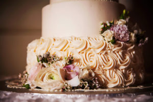 Ivory Rosette Icing and Floral Accents on Elegant Round Wedding Cake