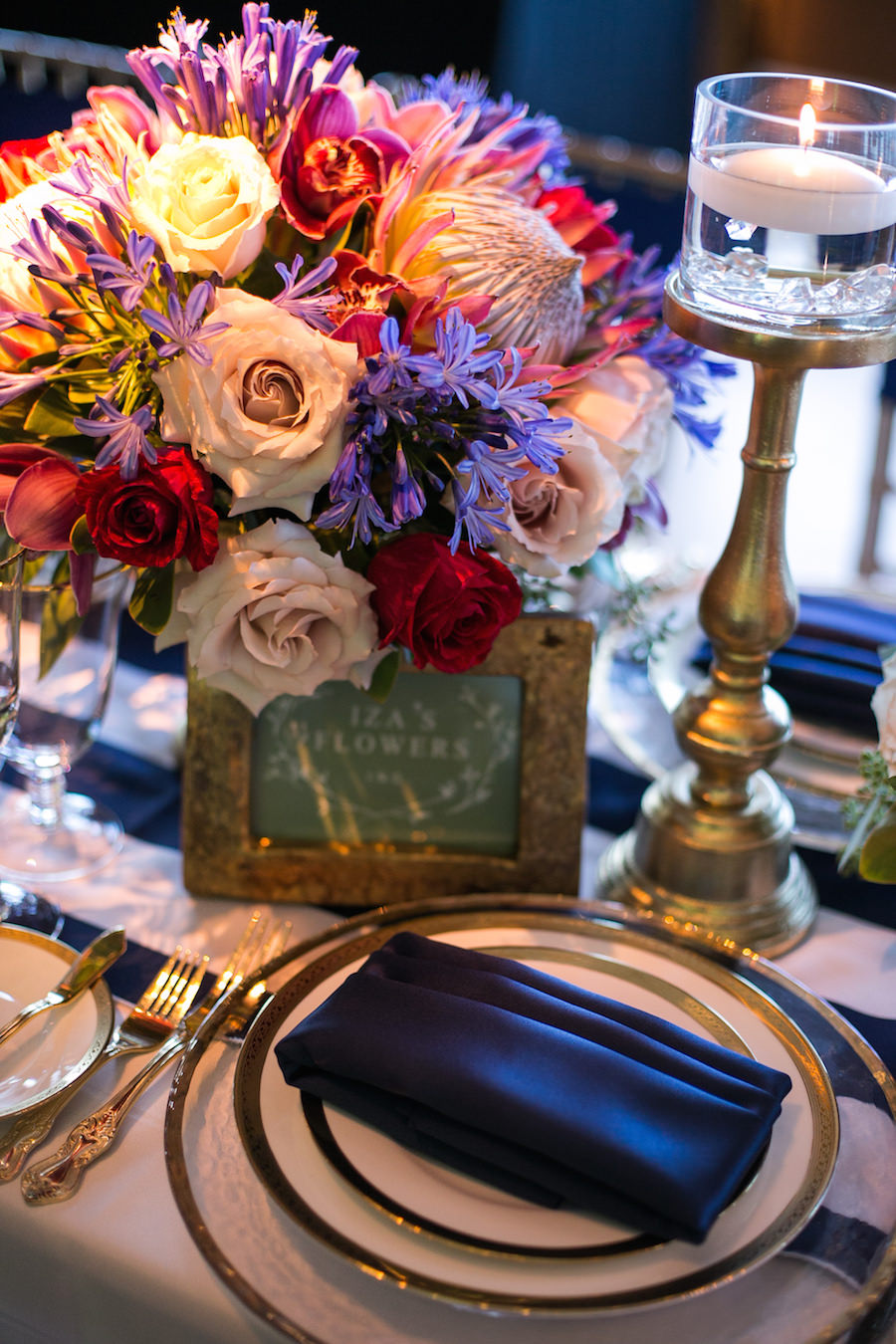 Tropical Pink and Purple Wedding Centerpiece by Iza's Flowers and Dish and Charger Rentals by A Chair Affair