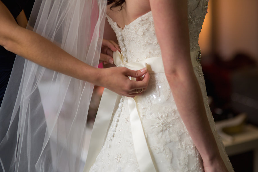 Getting Ready: Bride Getting Dressed for in Ivory, Strapless, Lace Wedding Dress