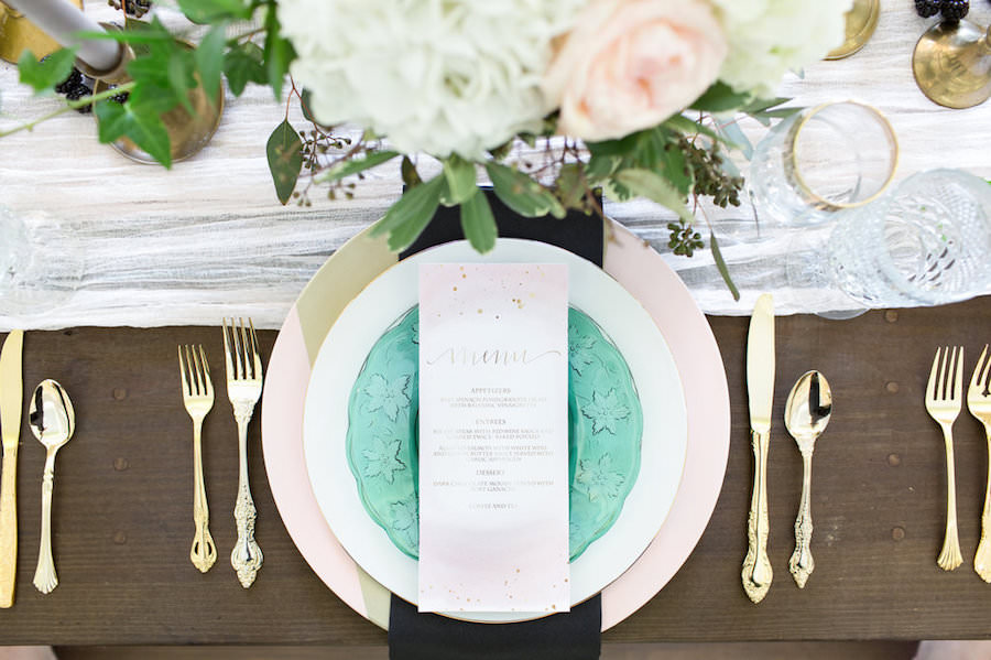 Ivory, White Rose and Blush Pink Wedding Centerpieces with Gold and Green Vintage China Charger and Gold Siliverware on Wooden Farm Table | Tampa Wedding Decor Ever After Vintage Rentals