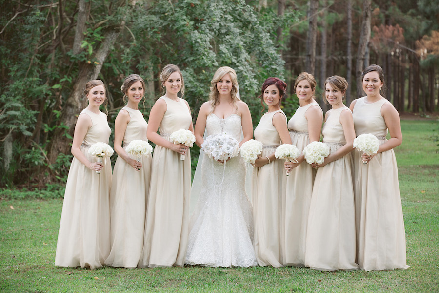 Outdoor Bridal Party Wedding Portrait | Cream A-Line Neiman Marcus Bridesmaid Dresses with Ivory Rose Bouquets and Ivory Sweetheart Allure Couture Lace Dress with White Brooch Bouquet | Tampa Wedding Floral Designer Northside Florist