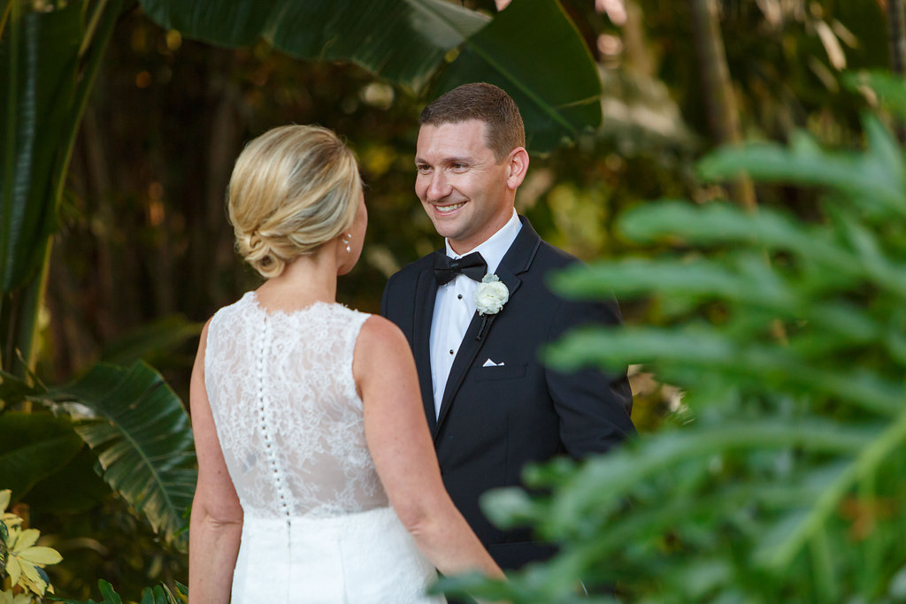 Bride and Groom Outdoor St. Pete Wedding First Look Portrait | White Lace Wedding Dress Detail with Satin Buttons and Groom in Tuxedo