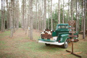 Rustic Outdoor Wedding Directional Sign with Vintage Trunk for Wedding Gifts on Green Vintage Pick Up Truck | Tampa Wedding Planner Glitz Events