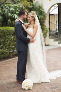 Outdoor, Bride and Groom Tampa Wedding Portrait in Lace, White Strapless Dress and Veil and Blue Suit