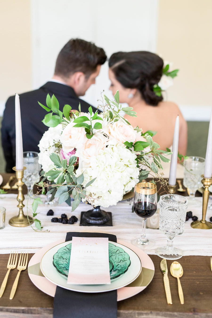 Ivory, White Rose and Blush Pink Wedding Centerpieces with Gold and Green Vintage China Charger and Gold Siliverware on Wooden Farm Table | Tampa Wedding Decor Ever After Vintage Rentals