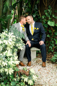 Same Sex Wedding Portrait in Navy and Gray Suits with Yellow Spider Mum Boutonnieres