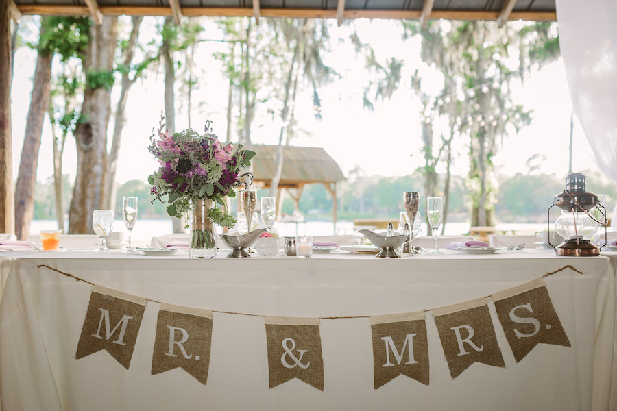 Rustic, Barn Wedding Reception Sweetheart Table Decor with Mr and Mrs Burlap Sign and Purple and Green Bridal Bouquet