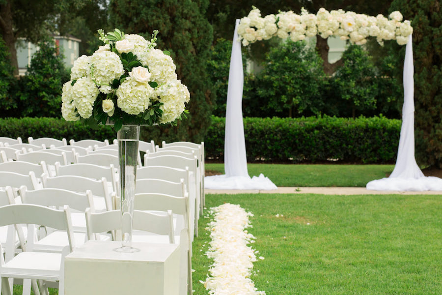 Outdoor Garden Wedding Ceremony With White Hydrangea and Tulle Arch with White Resin Folding Chairs | White and Gold Wedding Ideas | Tampa Wedding Venue The Palmetto Club | Jeff Mason Photography