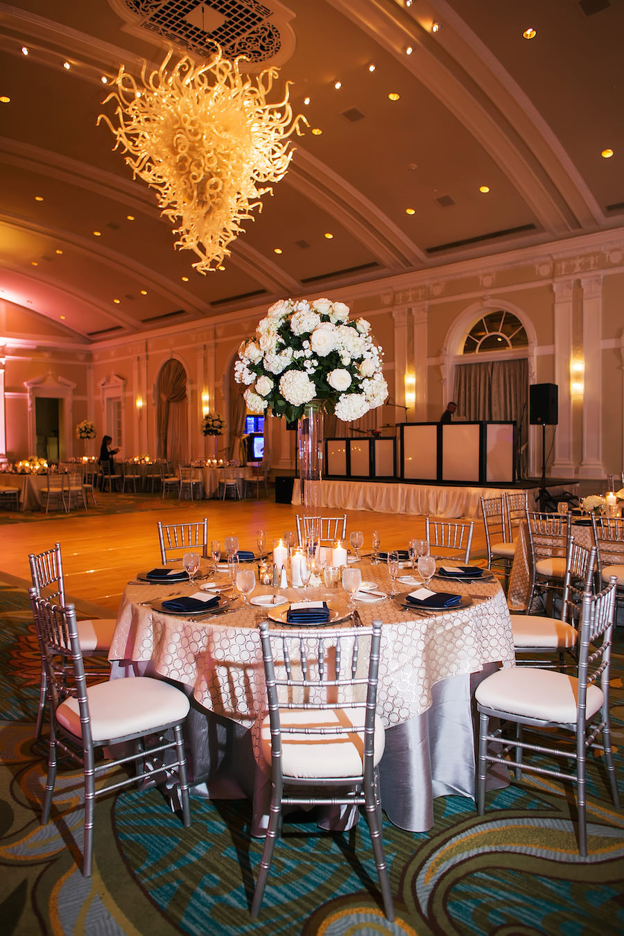 Classic Wedding Reception With Navy, White and Ivory Centerpieces, Silver Chiavari Chairs and Chihuly Chandelier | St. Petersburg Wedding Venue Vinoy Renaissance | Limelight Photography