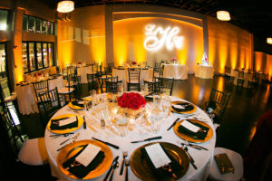Tampa Wedding Reception Table Decor with Gold Chargers, Black Chiavari Chairs, and Red Rose Centerpiece and GOBO Monogram Lighting