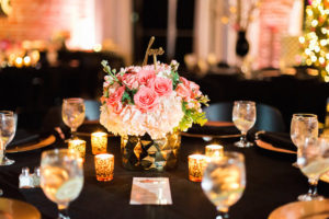 St. Pete Wedding Reception Table Decor with Candlelight and Ivory and Coral Bouquet of Flowers in Gold Centerpieces with Script Gold Table Numbers