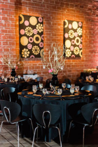 St. Pete Wedding Reception Table Decor with Wooden Twigs in Black Vase Centerpieces with Candles | Black and Chrome Wedding Reception Chairs| St. Pete Wedding and Event Space NOVA 535