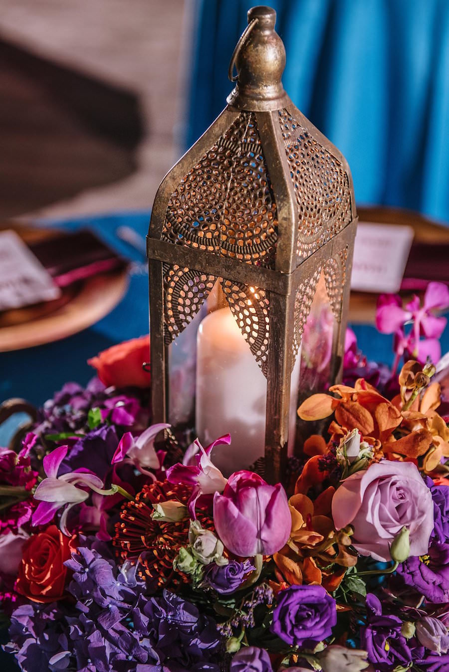 Wedding Reception Décor with Gold Moroccan Lanterns with Purple and Orange Floral Centerpieces on Teal Linens | Exquisite Events St. Pete Wedding Planner | Iza’s Flowers Wedding Florist