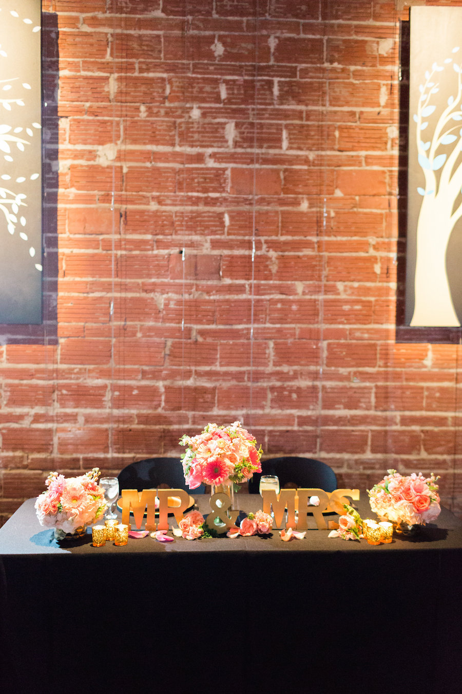 St. Pete Wedding Reception Sweetheart Table Decor with Gold Mr & Mrs Blocks and Coral and Ivory Flowers| Wedding Venues with Brick Walls in St. Pete Wedding and Event Venue NOVA 535