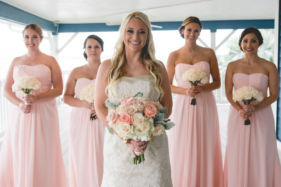 Outdoor Bridal Wedding Portrait of Bride and Bridesmaids in Lace, Ivory Modern Trousseau Wedding Dress and Pink Strapless Sweetheart Bridesmaids Dresses with Pink and Ivory Floral Bouquets of Roses