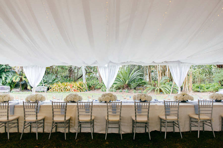 Wedding Reception Tent Table Decor with Silver Chiavari Chairs and White Hydrangea Floral Centerpieces | Sarasota Wedding Venue Marie Selby Gardens