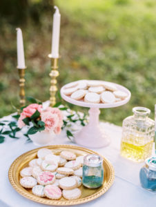 DIY Wedding Reception Favor Table with Hand Painted Cookie Bar and Tulle Tableskirt with Vintage Pieces and Garden Floral Arrangements with Blush, Purple and Ivory Flowers| Tampa Wedding Rentals by Ever After Vintage Rentals