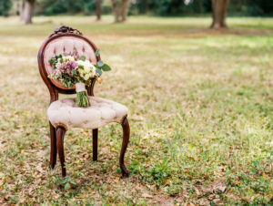 Vintage Outdoor Tufted Wedding Ceremony Seating with Bride's Purple Ivory and Greenery Bouquet | Tampa Vintage Wedding Seating and Chairs by Tufted Vintage Rentals