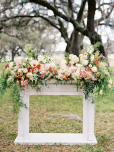 Floral Arbor Fireplace Garland for Outdoor Wedding Ceremony with Lush Arrangement of White and Pink Flowers with Greenery
