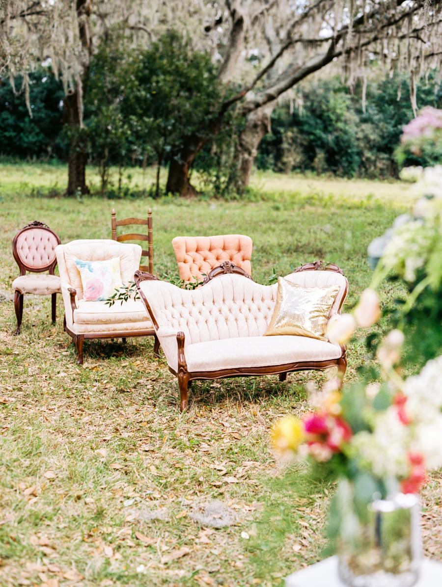 Vintage Outdoor Wedding Ceremony under Oak Trees with Mis-Matched Vintage Upholstered Chairs | Tampa Bay Vintage Wedding Rentals by Tufted Vintage Rentals