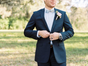 Wedding Portrait of Groom in Navy Suit with Bowtie and Pink Rose Boutonniere