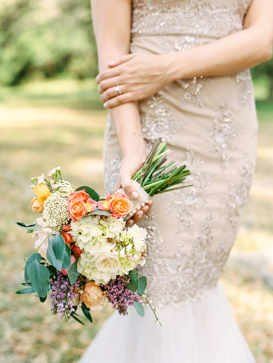 Ivory and Champagne Fit and Flare Wedding Dress with Gold Brocade Detail and Garden Inspired Bride's Wedding Bouquet