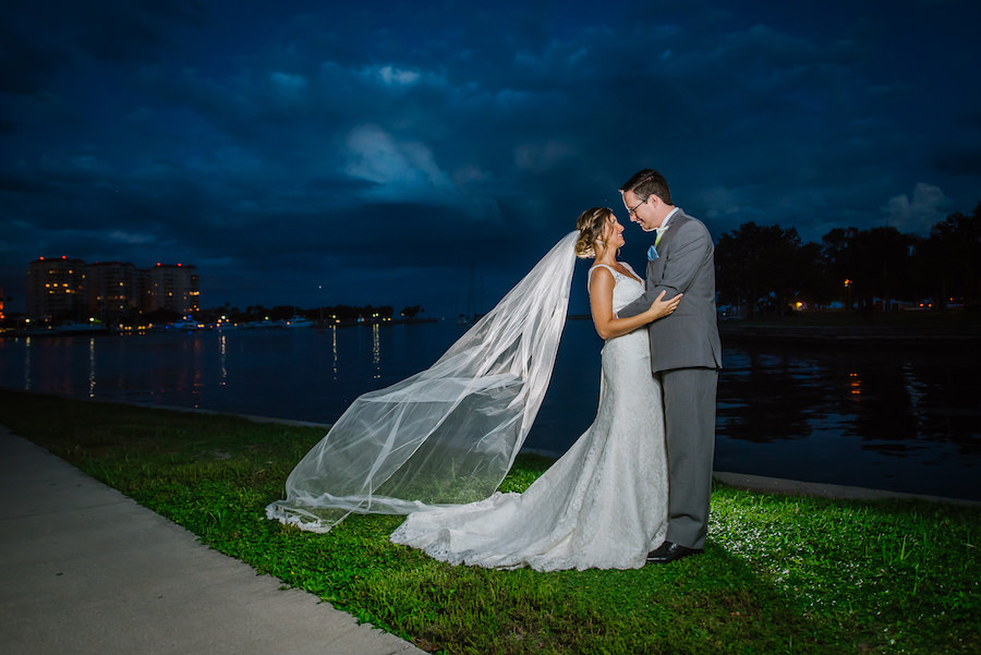 St. Petersburg Waterfront Bride and Groom Wedding Portrait in Grey Suit and Augusta Jones Lace Wedding Dress with Cathedral Veil