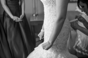 Bride Getting Dressed in Strapless, Ivory, Beaded Lace Wedding Dress| Tampa Wedding Photographers Caroline and Evan Photography