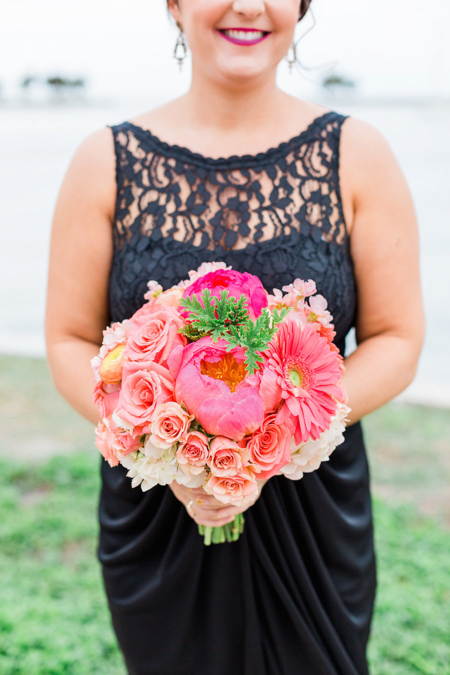 St. Pete Bridesmaid in Navy Blue Bridesmaids Dress and Bright Coral and Pink Wedding Bouquet of Flowers
