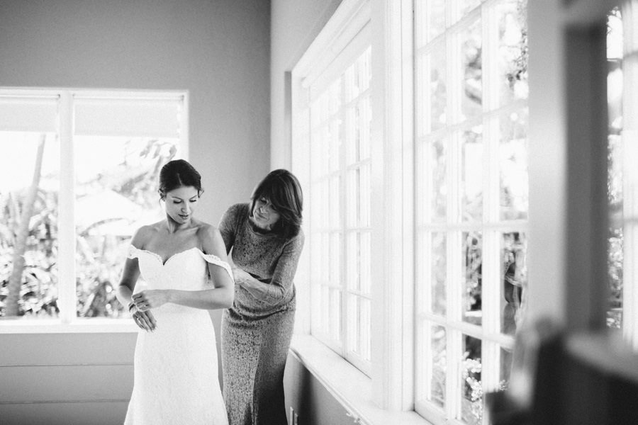 Bride Getting Ready Putting on Wedding Dress with Mother