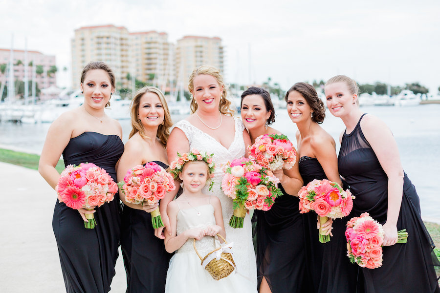 Bride and Bridesmaids St Pete Wedding Portrait in Navy Blue Bridesmaids Dresses and Ivory Wedding Dress with Straps and Coral and Pink Bouquets of Flowers