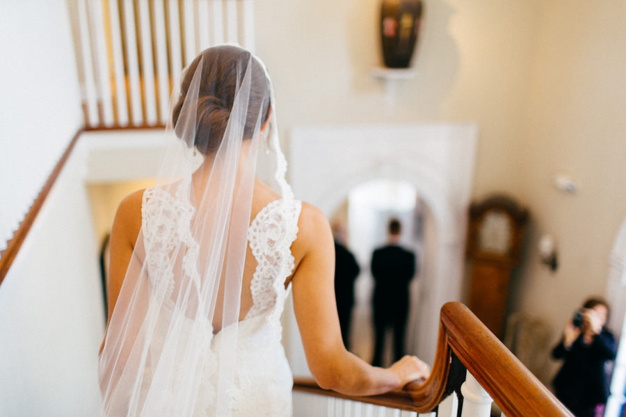 Bride Walking Down Staircase in Ivory, Lace Wedding Dress and Veil