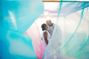 Waterfront Bride and Groom Beach Wedding Portrait with Blue and Pink Sheer Linens | St. Pete Beach Wedding Planners Tide the Knot Beach Weddings