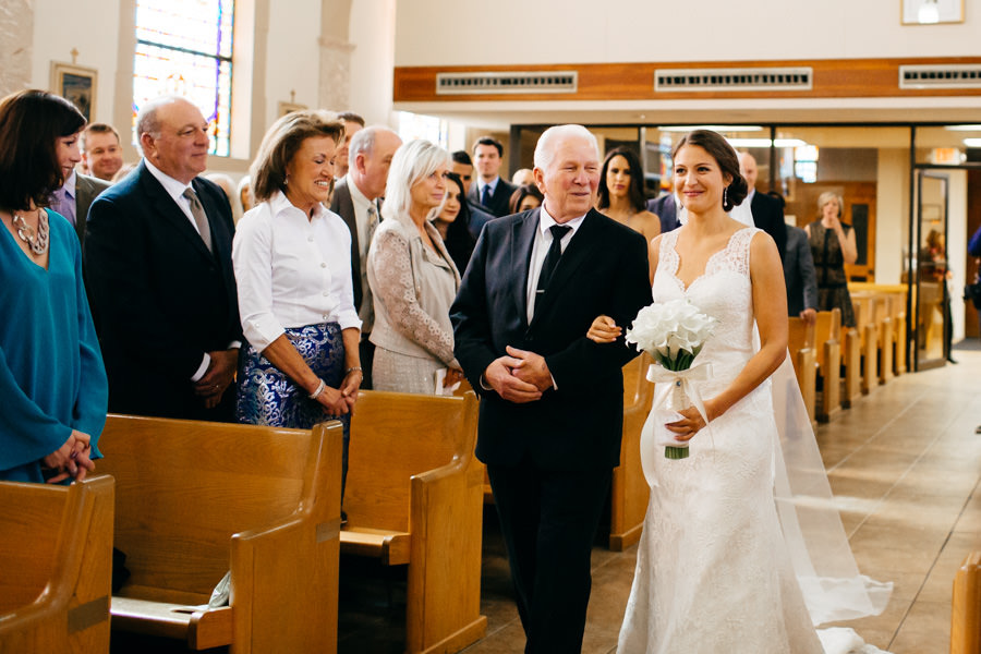 Bride and Dad Walking Down the Aisle at Sarasota Catholic Church Wedding Ceremony at St. Martha's Catholic Church