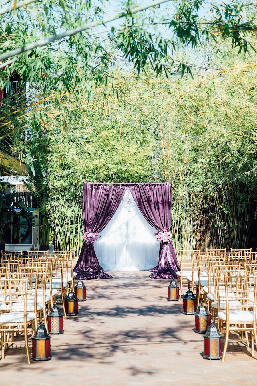 Outdoor Wedding Ceremony at St Pete Wedding Venue NOVA 535 with Purple Linen Flocked Archway and Gold Chaivari Chairs | St. Petersburg Wedding Chair Rentals Signature Event Rentals | Wedding Planner Exquisite Events