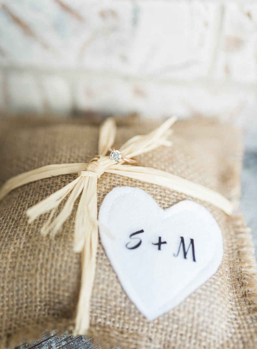 Engagement Ring Wedding Detail on Personalized Burlap Pillow with Bride and Groom Initials