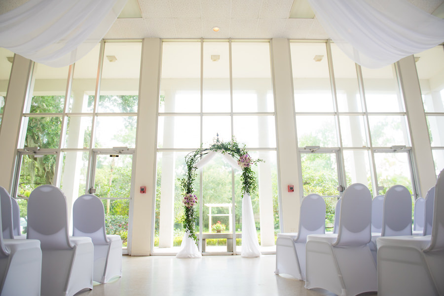 Purple, Green and White Garden Theme Wedding Ceremony at the Tampa Garden Club with White Chairs and White Tulle Ceiling Draping | South Tampa Wedding Florist Apple Blossoms Floral Design | Tampa Wedding Photographer Kera Photography